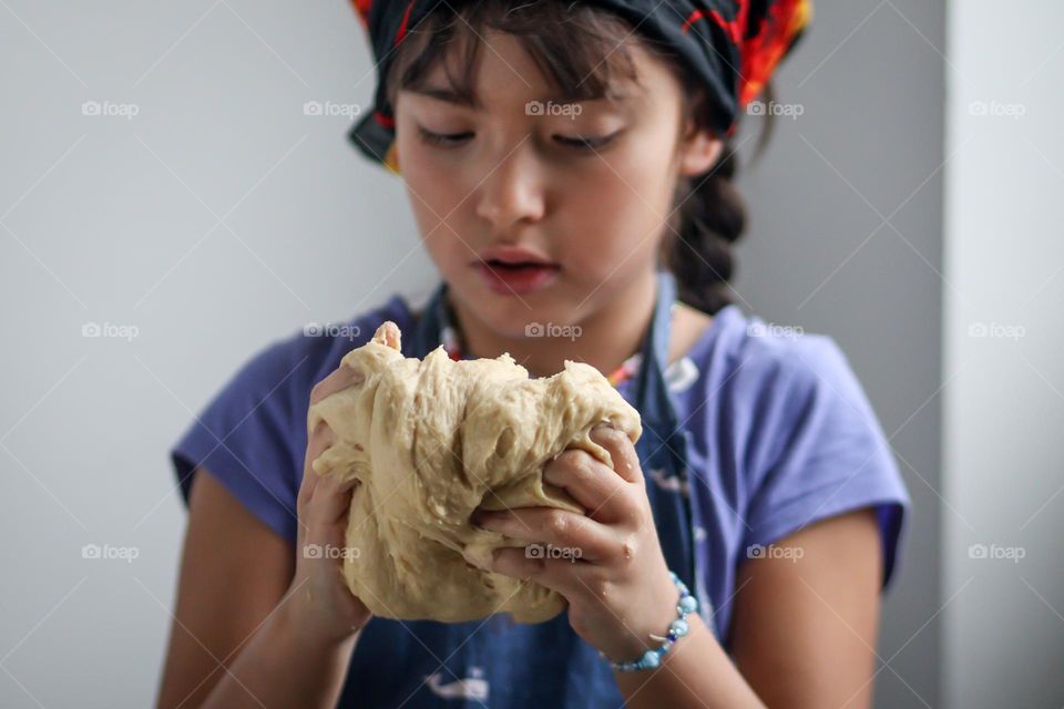 Cute little girl with a dough