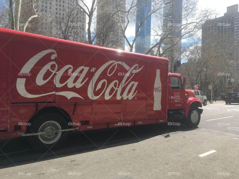 Coca cola truck plowing through the urban jungle of New York 