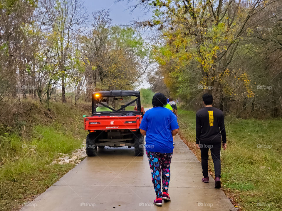 Red Gravely AWD  Jobsite vehicle on a cement park path with walkers