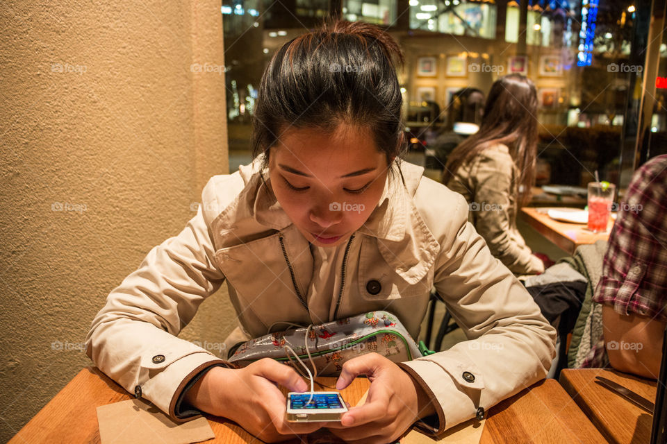 Girl playing smartphone 