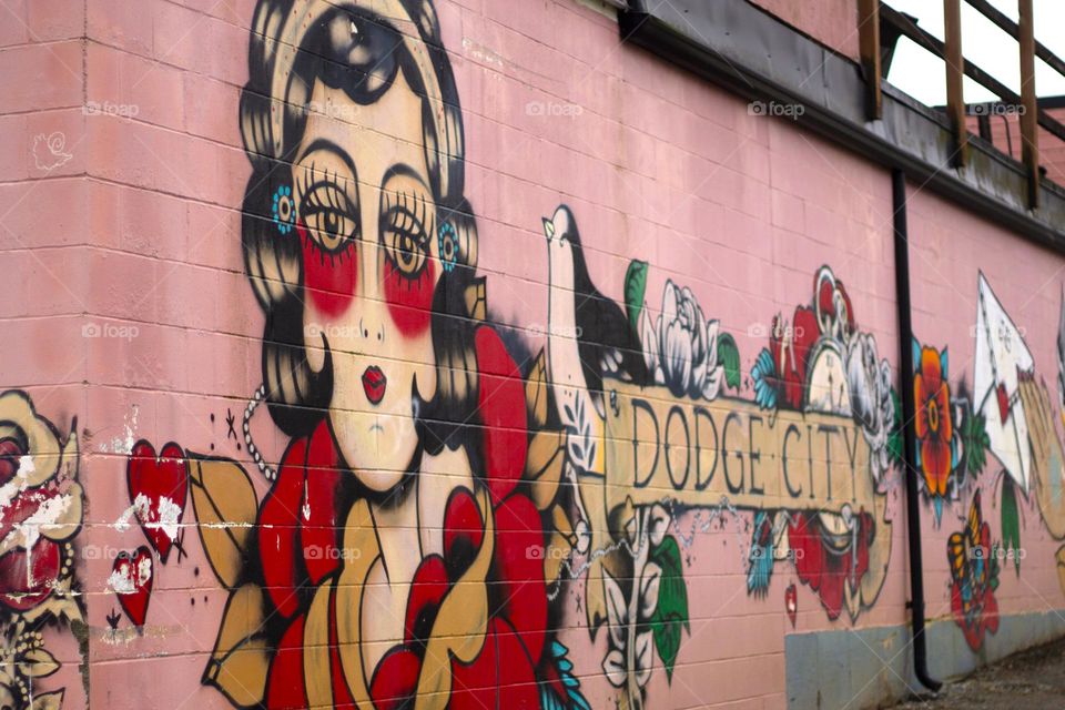 Colourful vintage art is on full display on the side of a building in a nearby village known for its vibrant public art.  