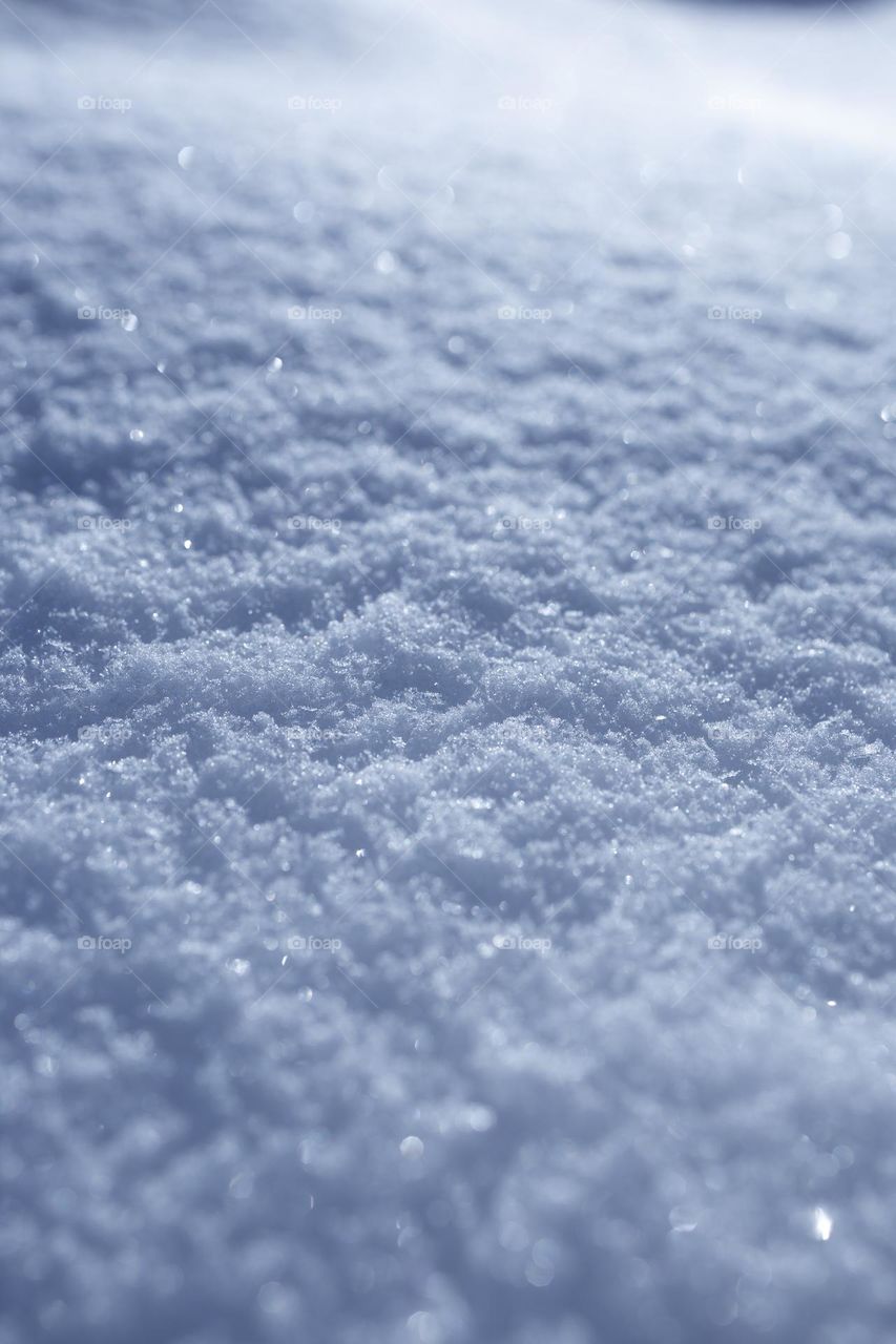 Selective focus snow background with flickering defocused snowflakes. 