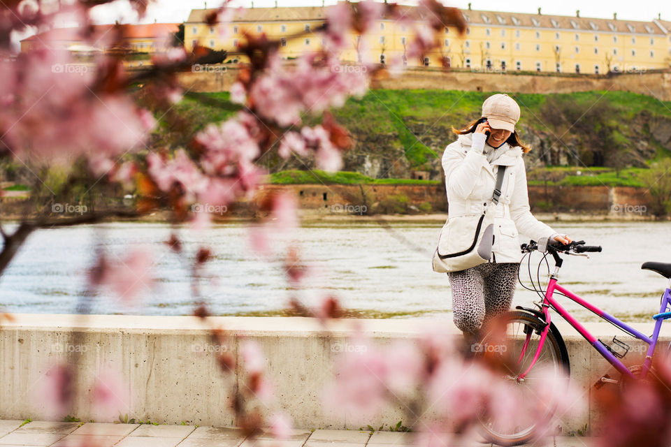 woman talking on the phone. woman with her bike having a break while talking on the phone