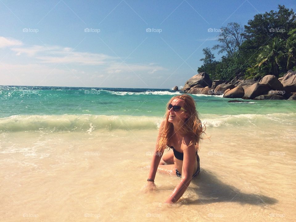 Sexy woman sitting on beach
