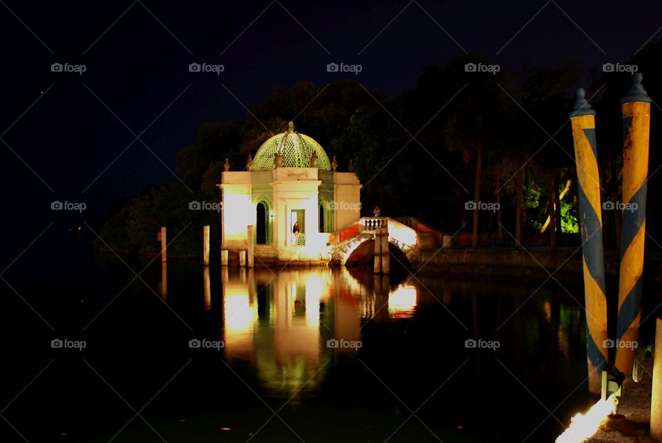 a peaceful gazebo reflecting in still water