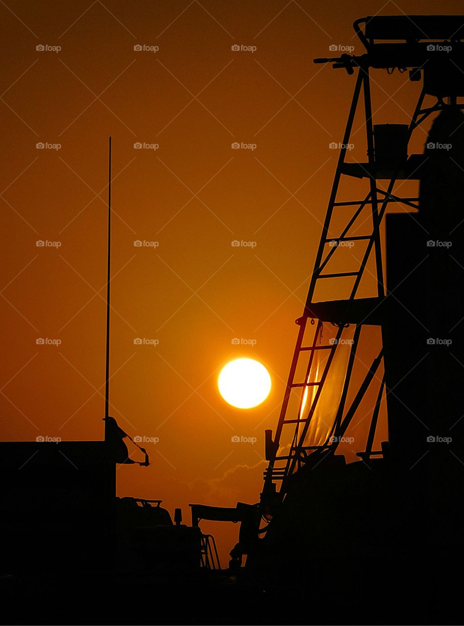 Magnificent sunset over fishing docked fishing vessel. 