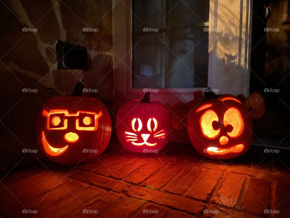 Lit jack-o-lanterns at night halloween pumpkin carving spooky