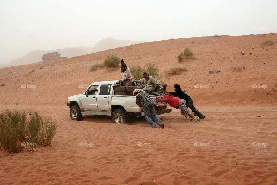Extrication of pick-up truck from the dunes sand while road trip