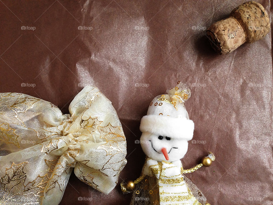 Christmas postcard made of funny snowman, champagne cork and gift sack 