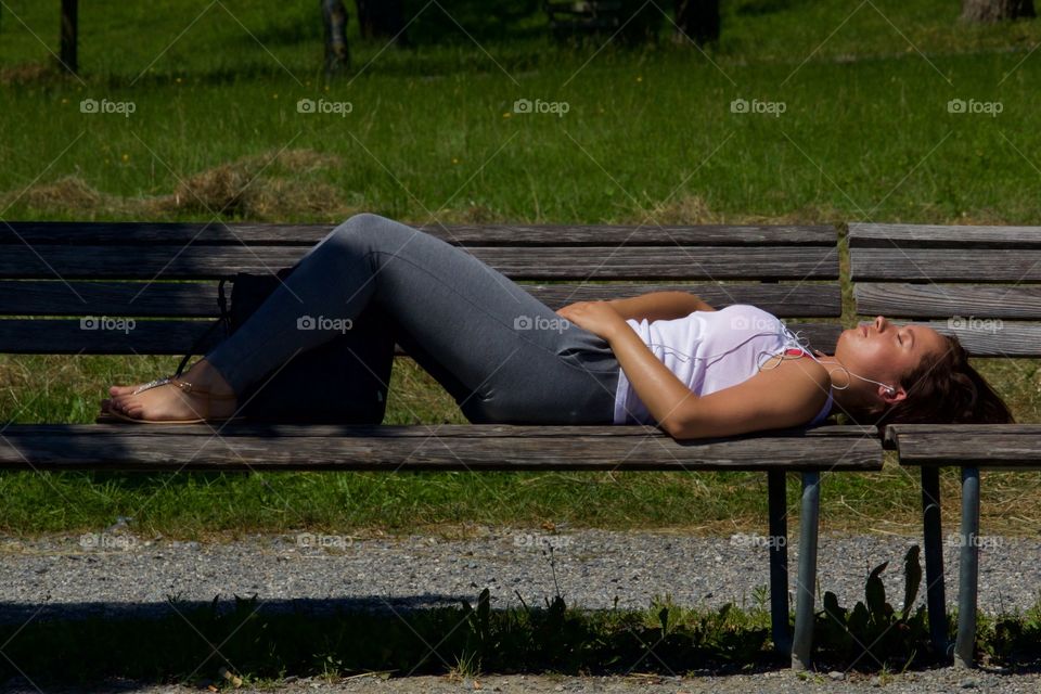 Girl Taking  A Nap On Wood Bench