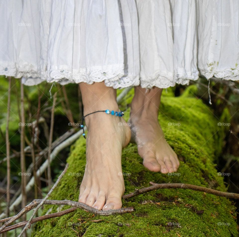 Dancing woman into the forest . Barefoot and mysic in her summer dresses.