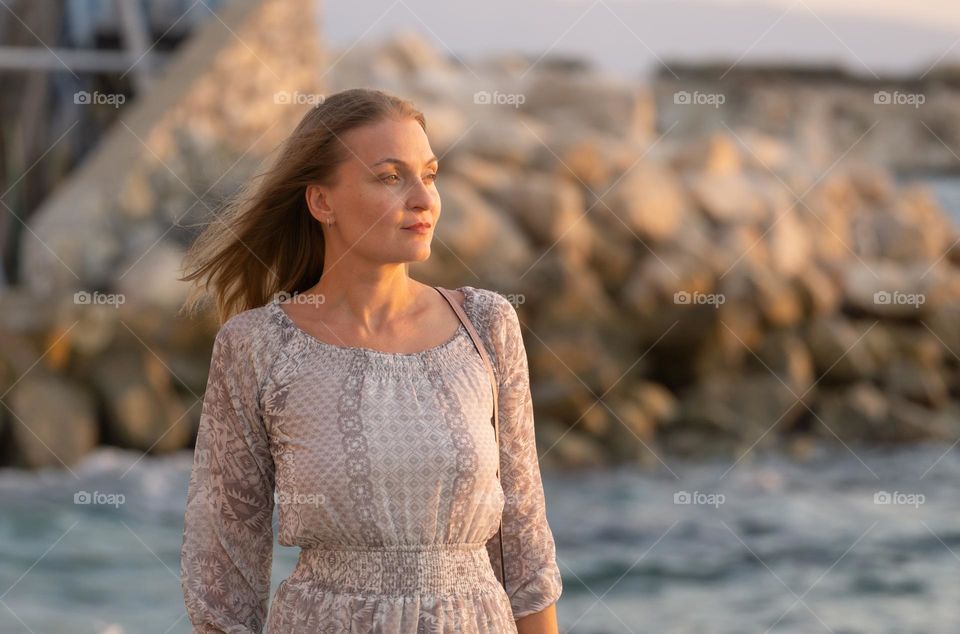 A woman and the sea at golden hour 