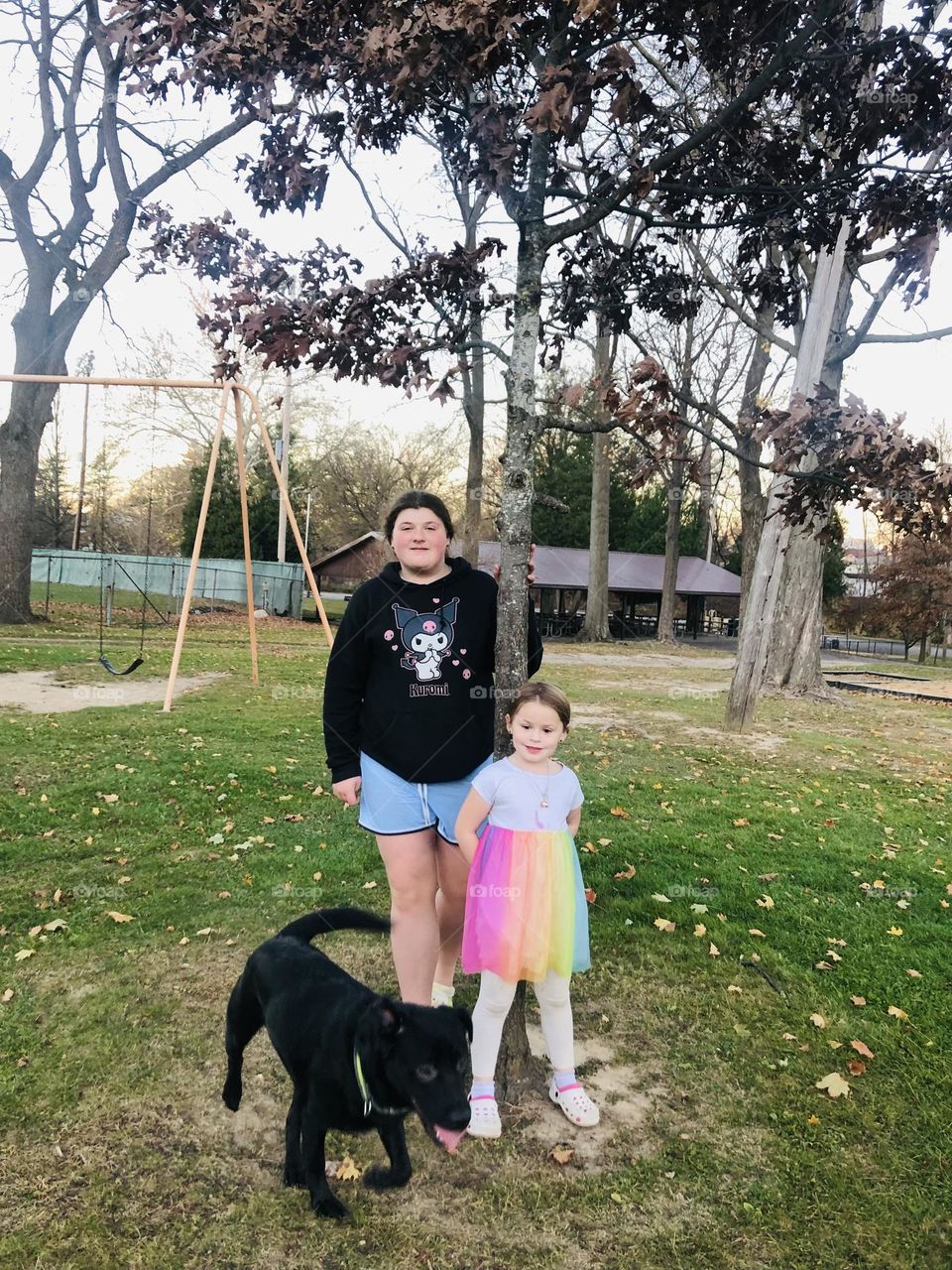 My two beautiful baby girls and taz at the park posing under the tree