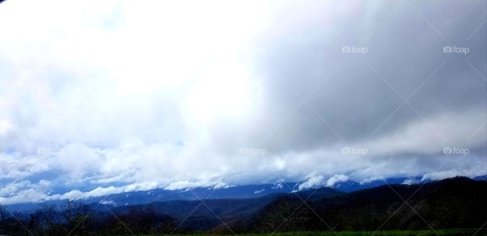 Massive white clouds and amazingly blue skies over Smoky mountains.
