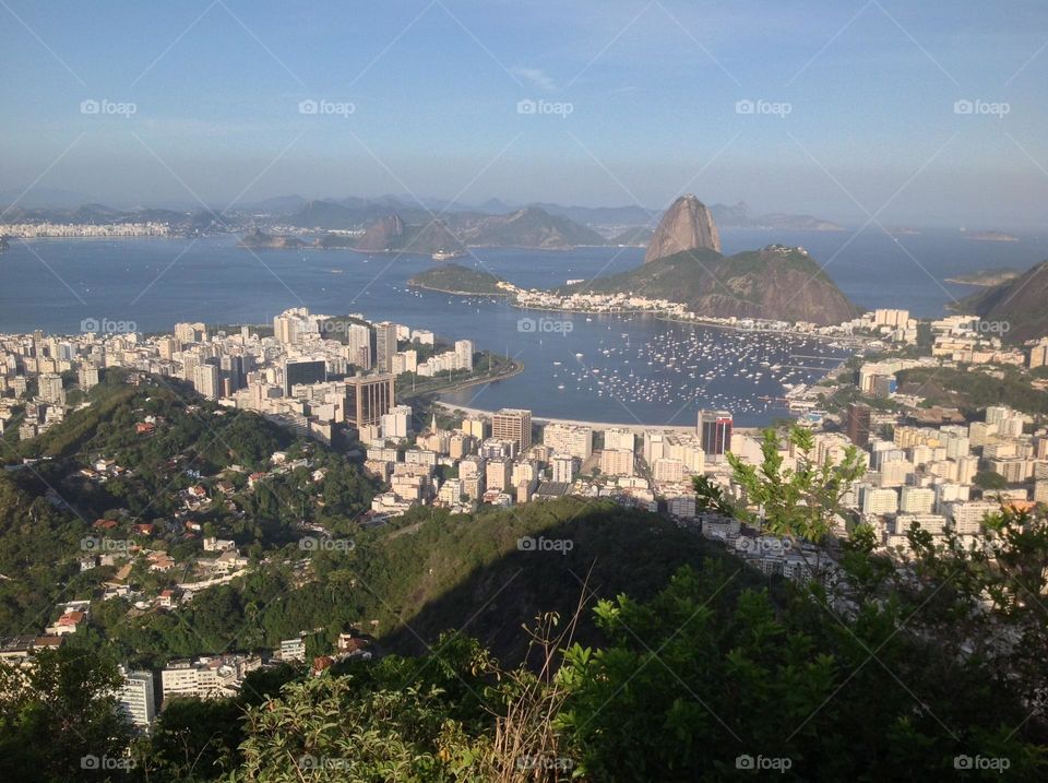 The famous view of the Sugarloaf in Rio de Janeiro from Corcovado, where the statue of Christ, the redeemer opens its arms to protect the Guanabara bay