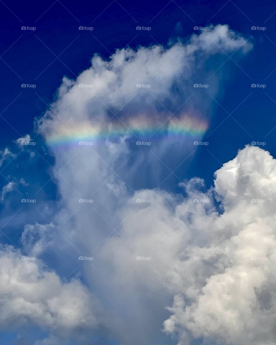 A rainbow inside of a billowing cloud