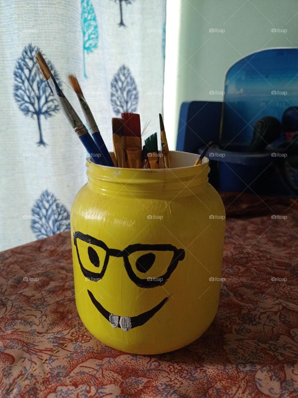 Penting bresh holding jar made by West Plastic jar with smile face drawing it's looking beautiful Nice craft art it was a West in to best consept