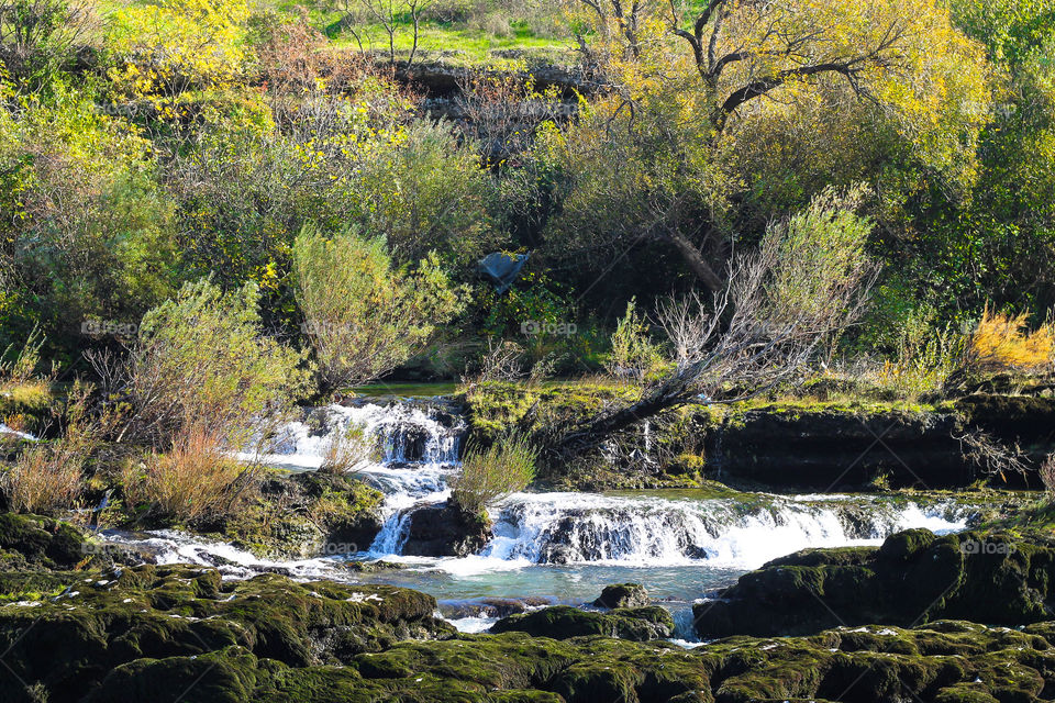 View of river flowing through rock
