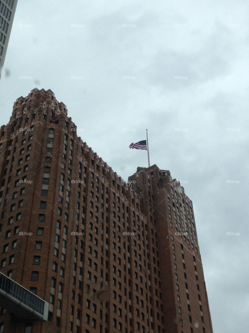 America Stands Strong . September 11, 2015...a lone American flag waved atop this building in Detroit as the rain sprinkled.