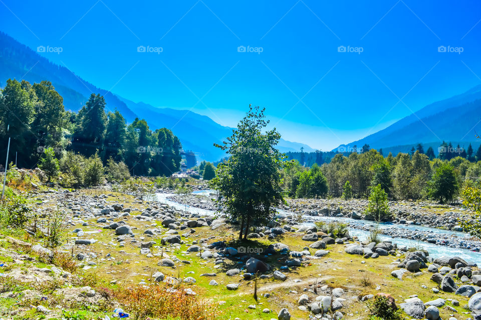Mountain valley during bright sunny day. Beautiful natural landscape in the summer time.Mountain valley during sunny day. Natural summer landscape. Travel nature background poster concept