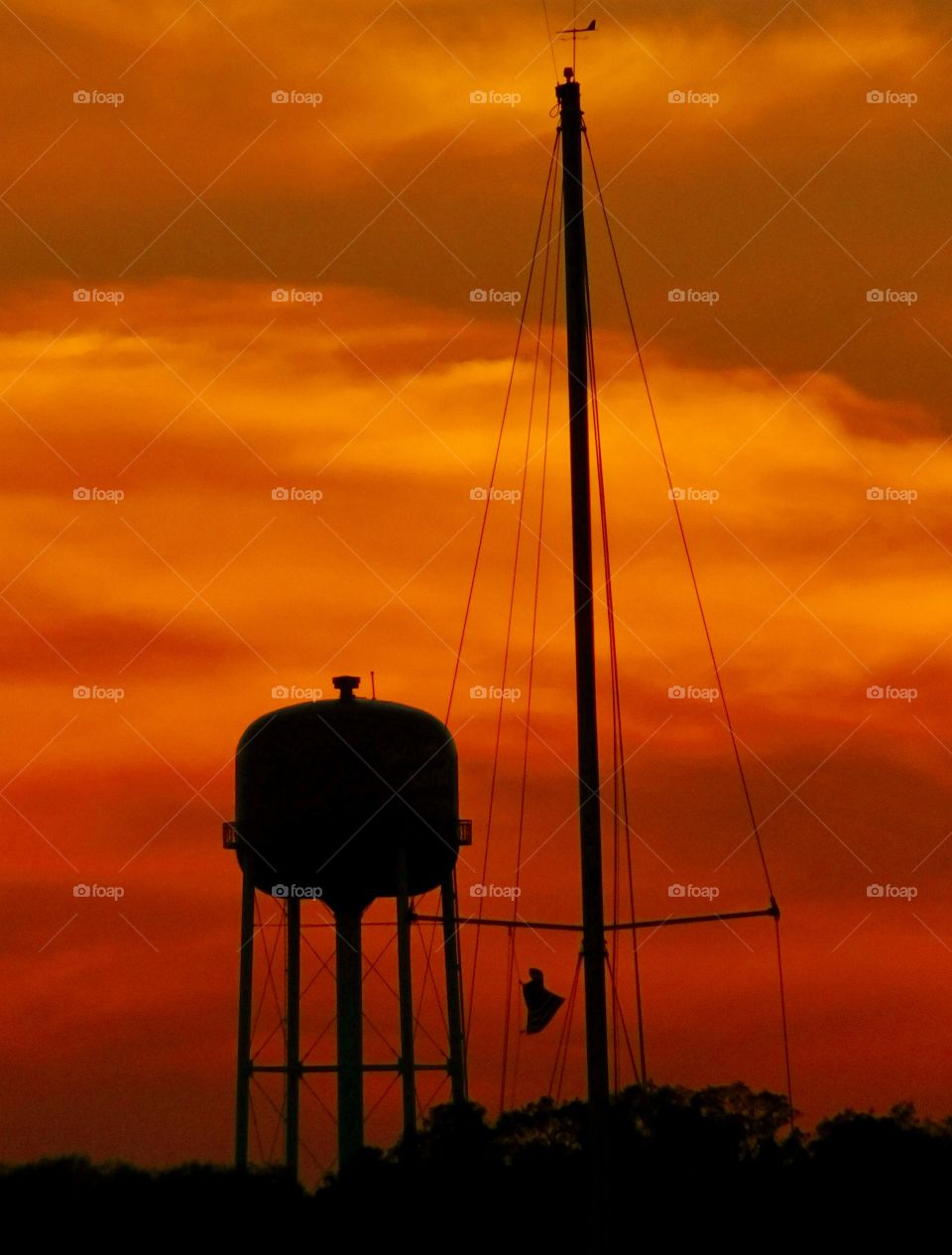 A water tower silhouette in the sunset