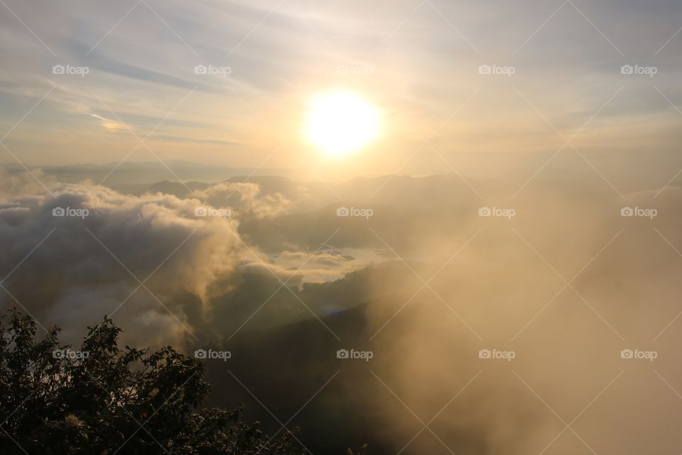 Clouds surrounding mountains at morning