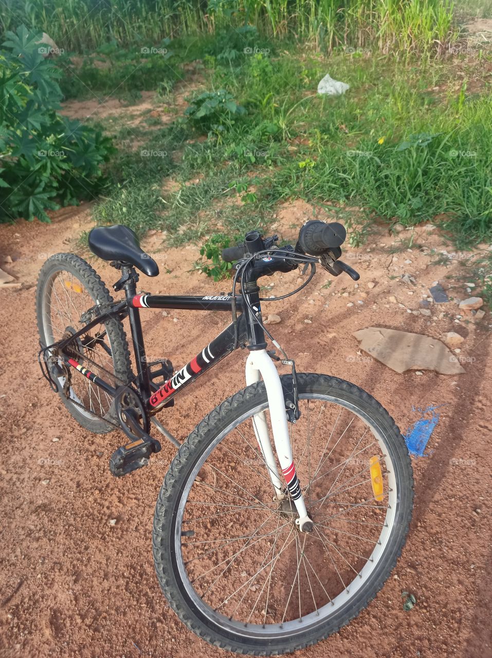 bicycle on the mud road 
rural scene