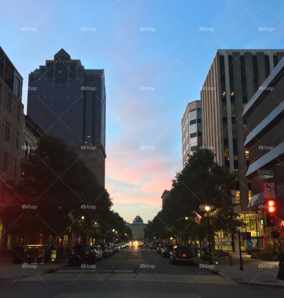 Downtown Raleigh, North Carolina facing the North Carolina State Capitol building at dusk.