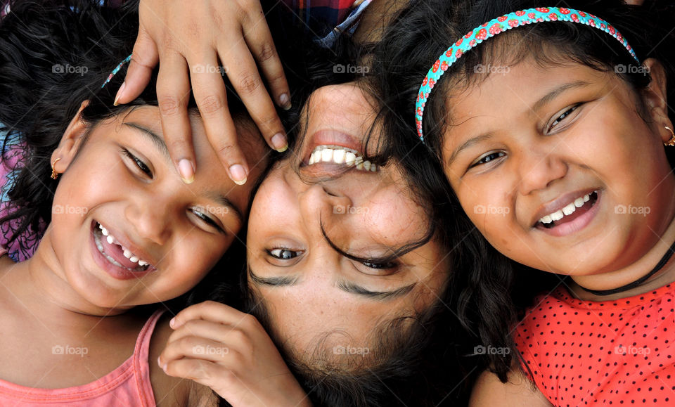 mother and daughters smile