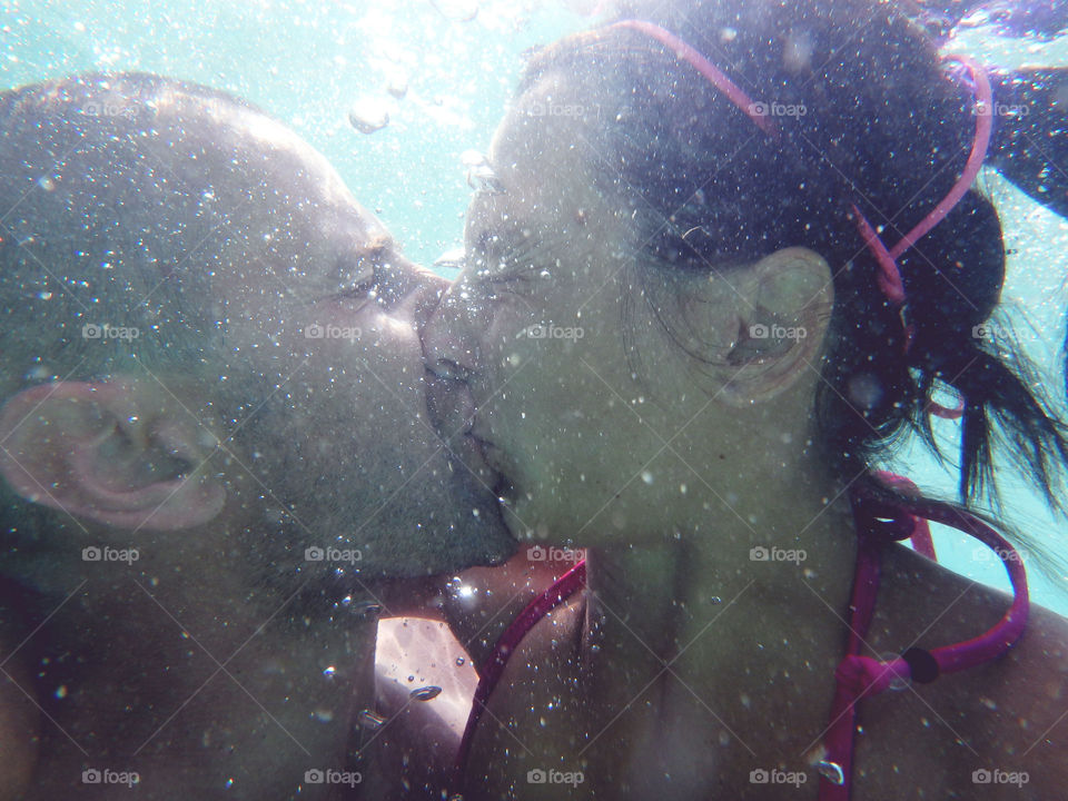 underwater kiss. young couple kisses underwater