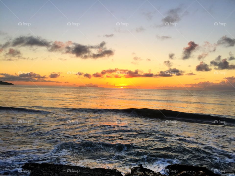 Scenic view of sea against sky at sunset