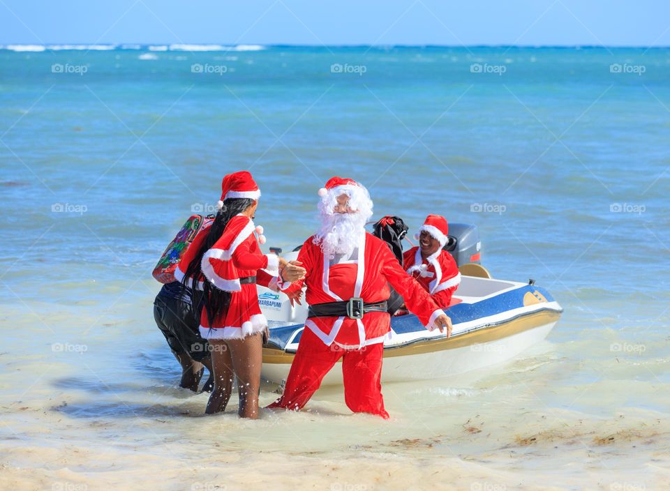 Santa in the antipodes getting out his ride in the bright sun