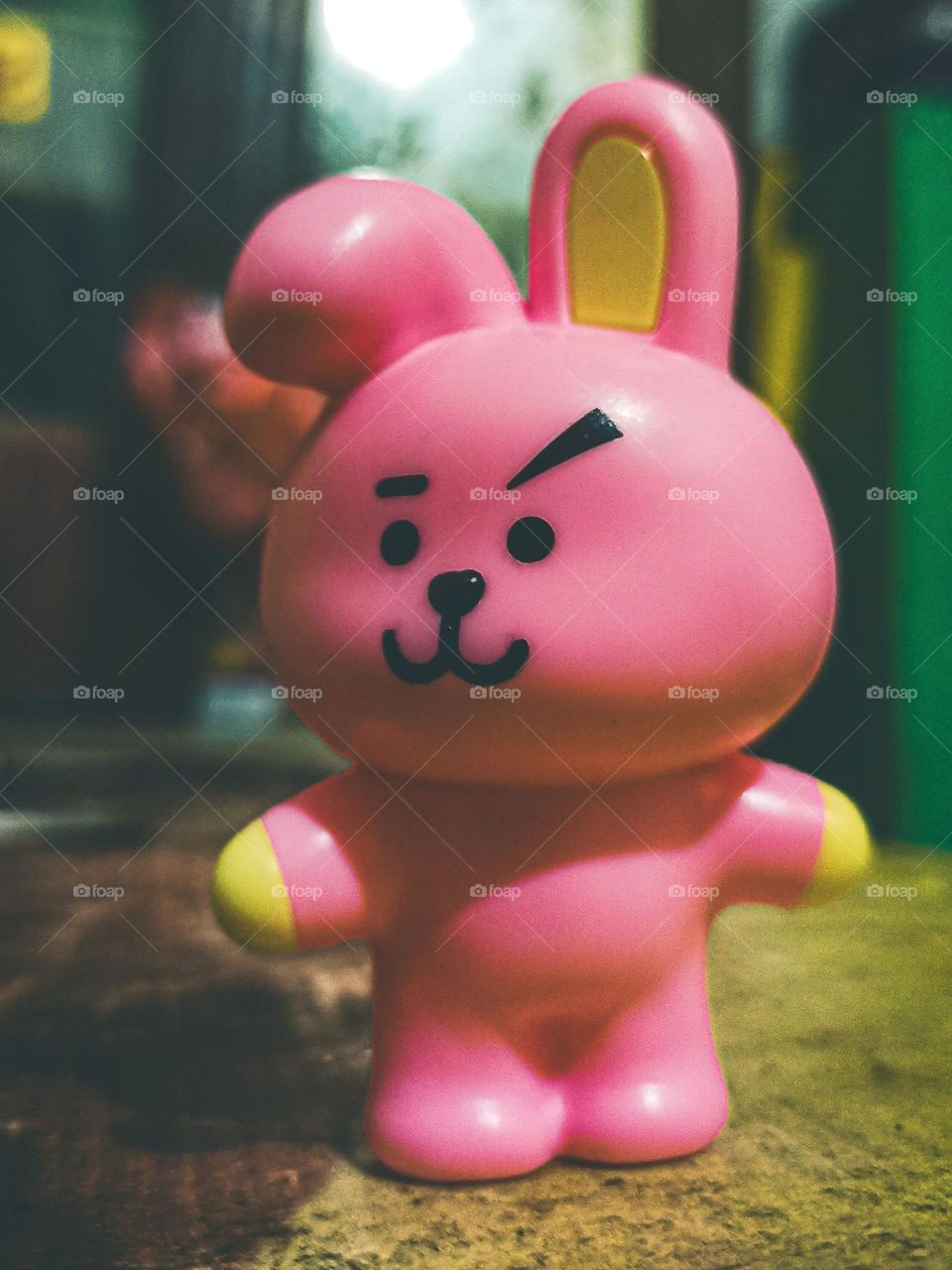 Close-up of a pink rabbit-shaped toy with a cheerful facial expression