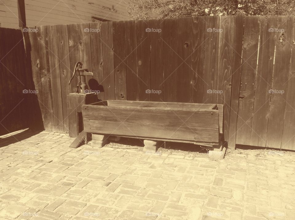 a closer shot of an old water trough with pump at the History Park in san jose, ca