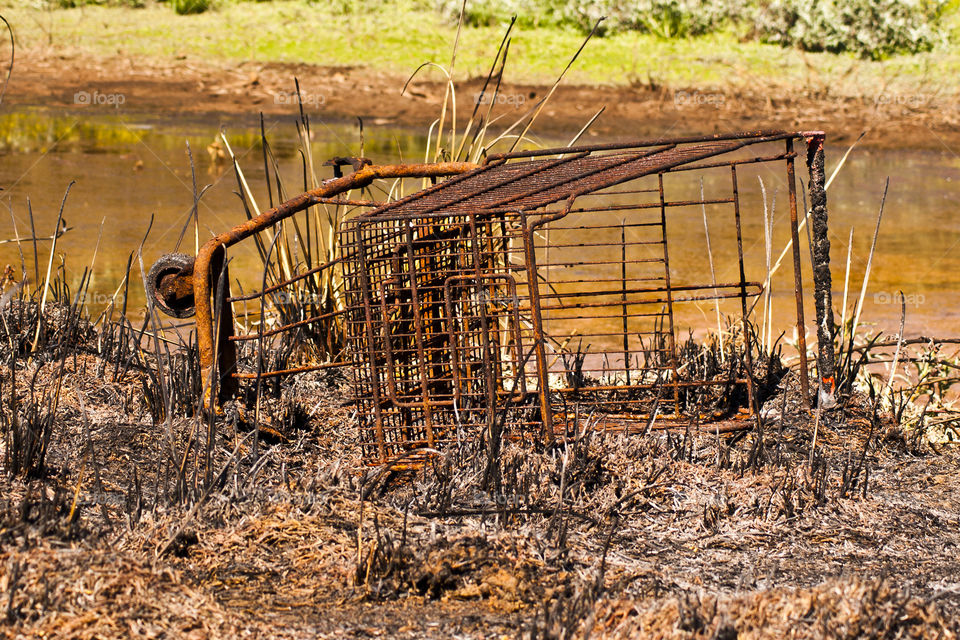 Trolly rusted next to some water