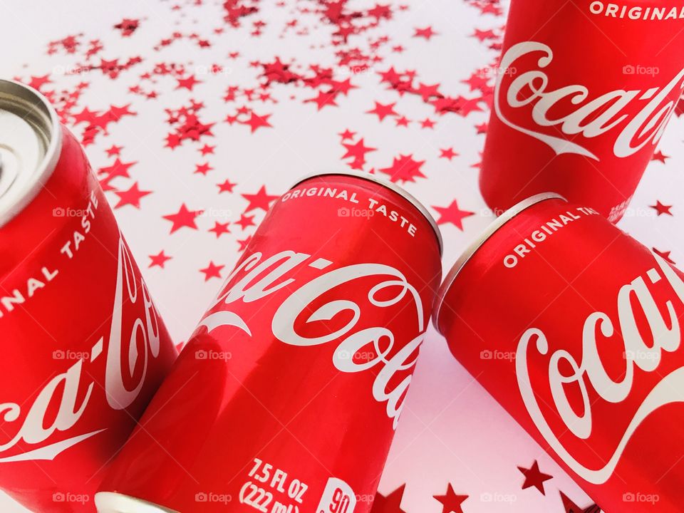 Coca Cola on a white background with red stars