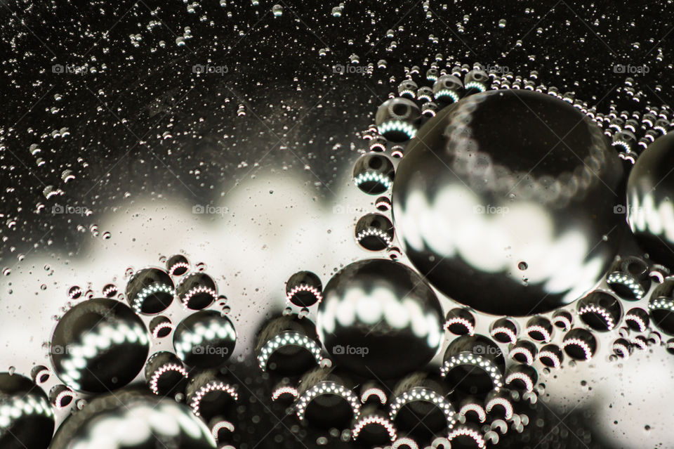 Small bubbles of vegetable oil in water close-up.