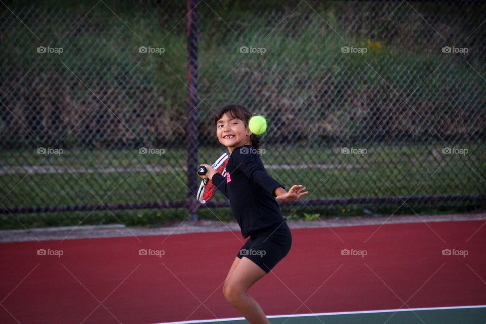 Cute funny girl in playing tennis