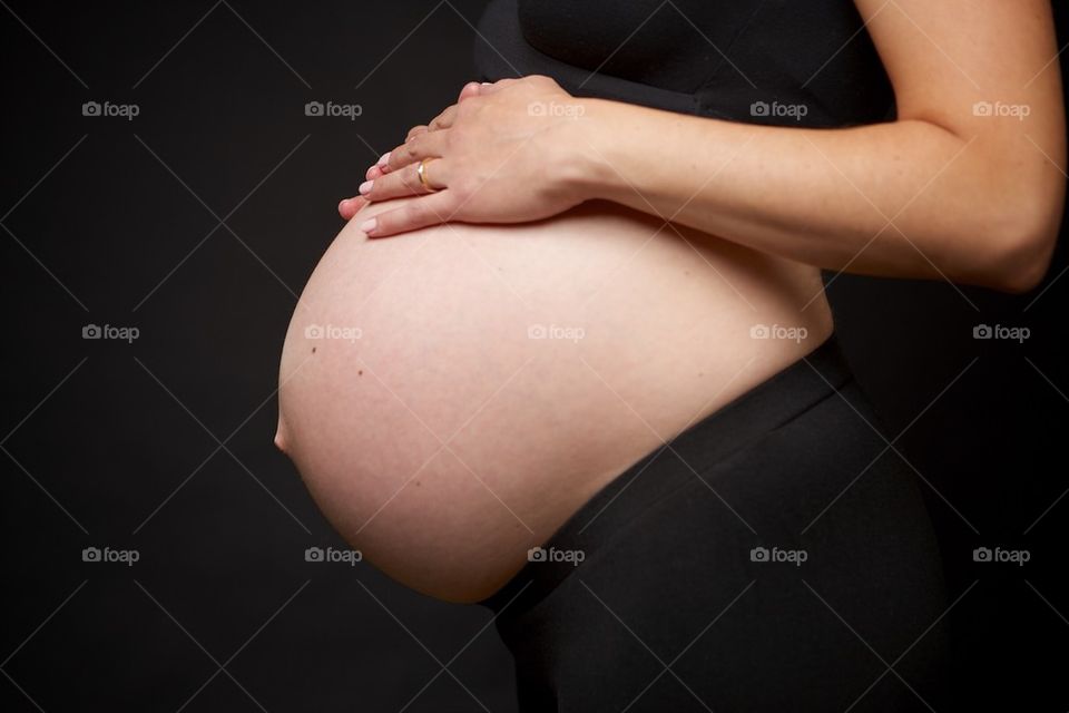 Hands on pregnant belly 
