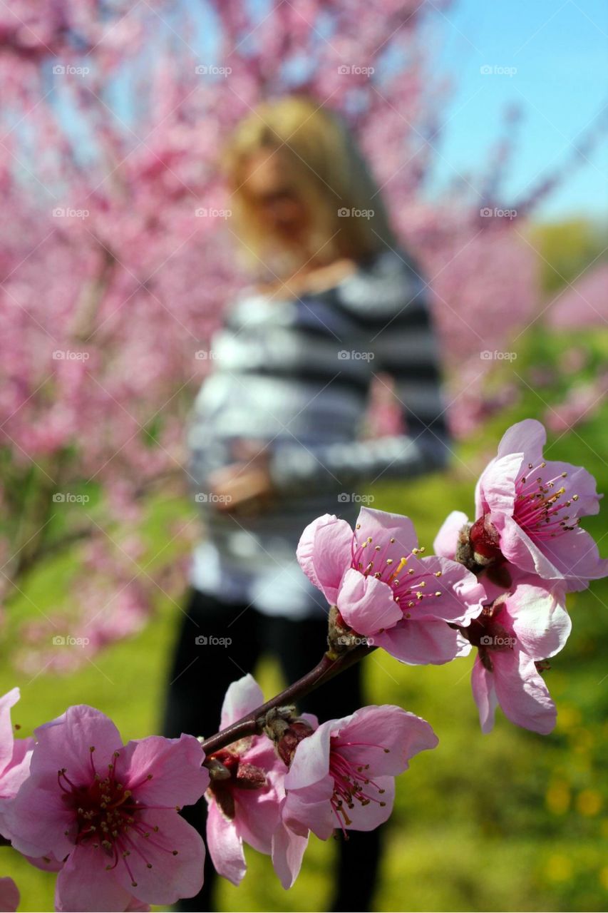 Pregnant woman standing in garden