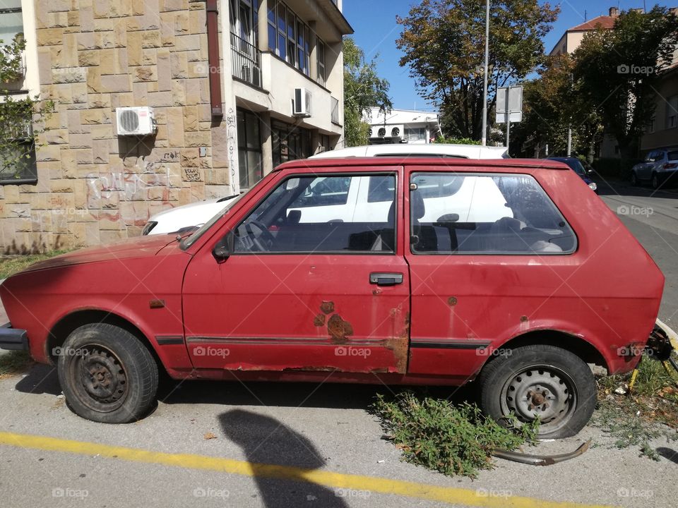 Old rusty car on street