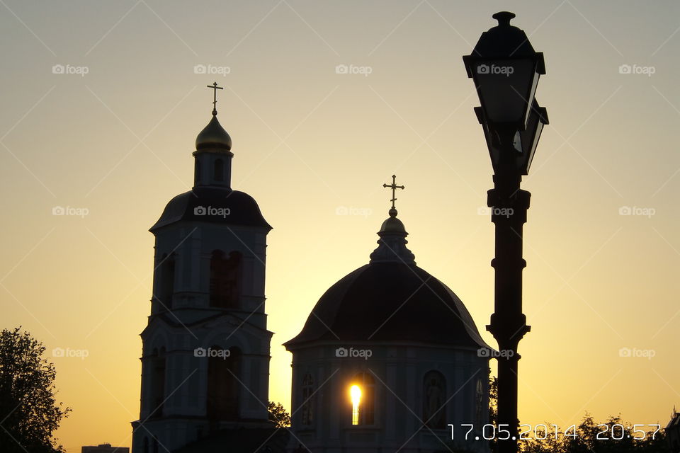 The setting sun, in the windows of the Orthodox church, formed a candle. No photoshop and editors.