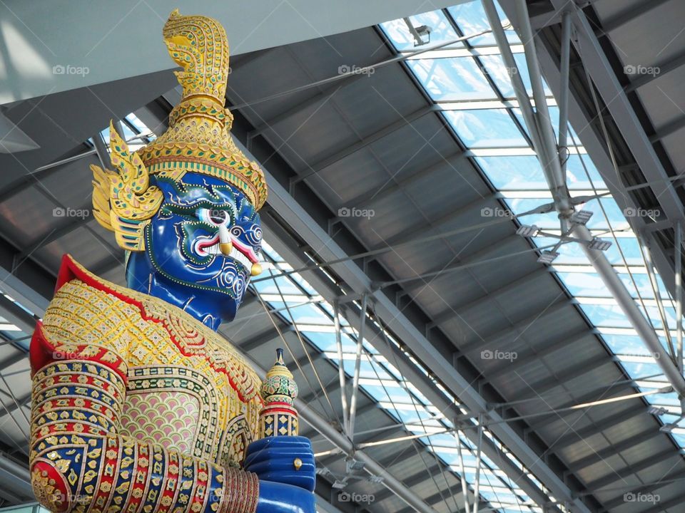 A huge statue erected inside an airport terminal.