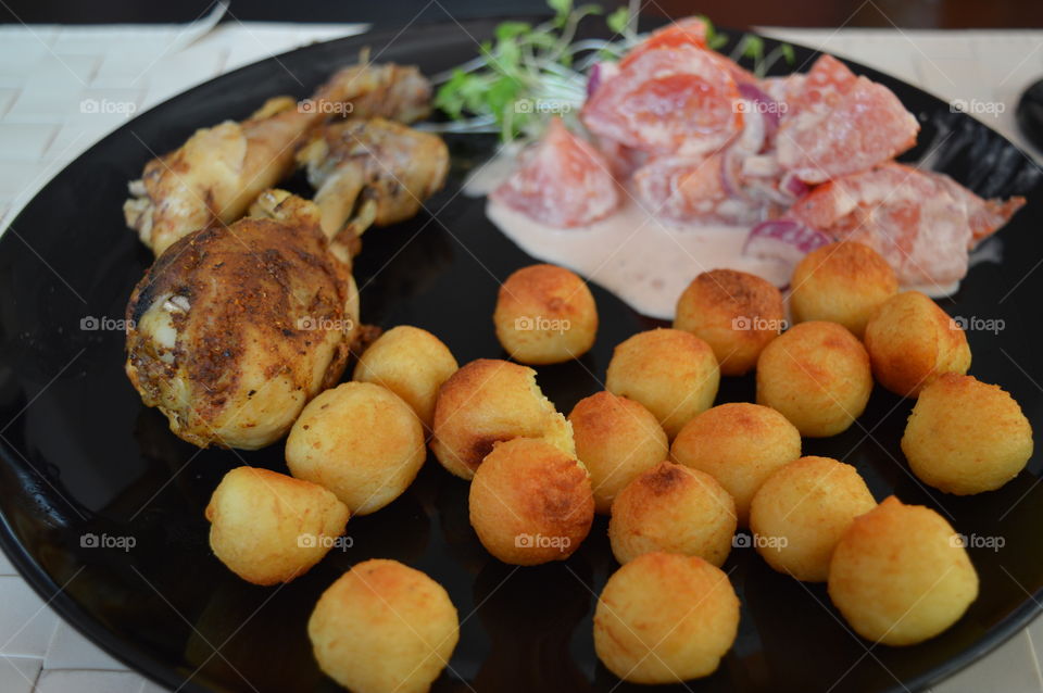 chicken with potatos balls and fresh salad