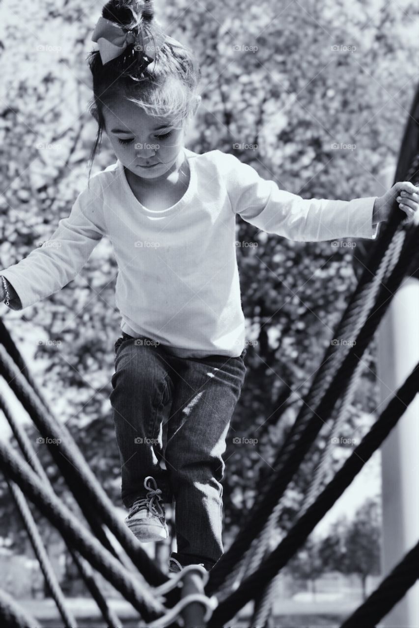 Cute girl walking on rope