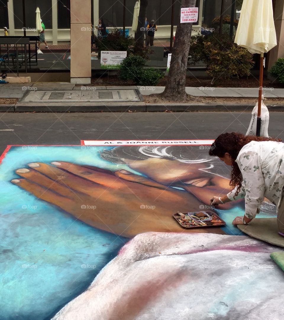 Working on street chalk art