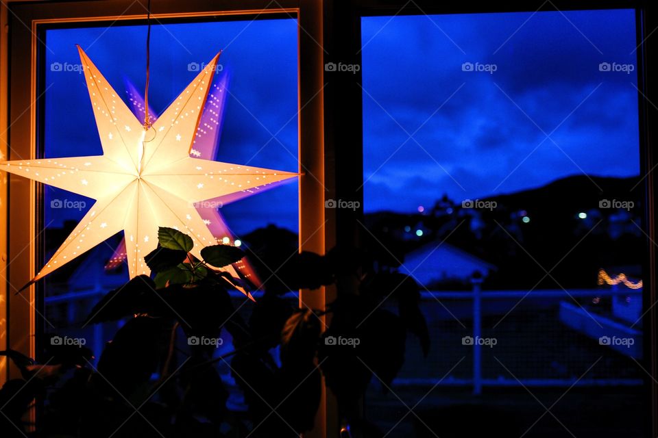 Illuminated star on glass window