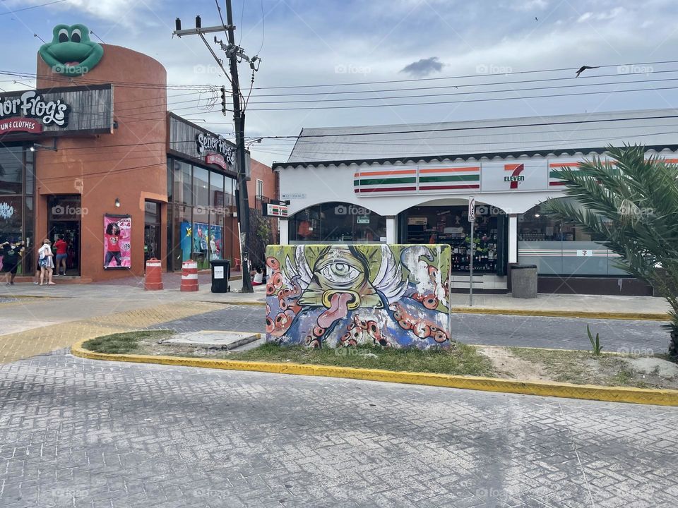 Illuminati sign mural on the street of Isla Mujeres, Mexico.