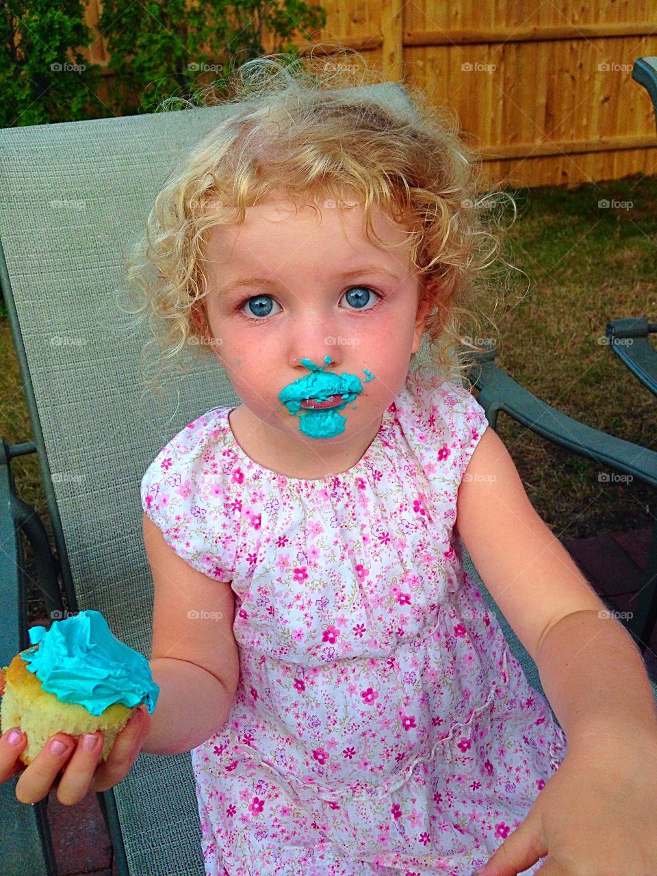 Is there something on my face?. I think she wore more of her cupcake than she ate...
