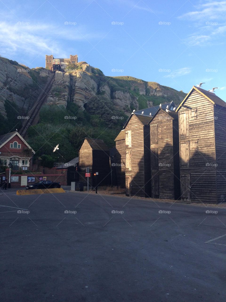 Fishing net huts and East Hill funicular cliff railway, Rock-a-nore, Hastings, East Sussex. These huts are an icon of the town and part of fishing history. The railway is the steepest in the UK
